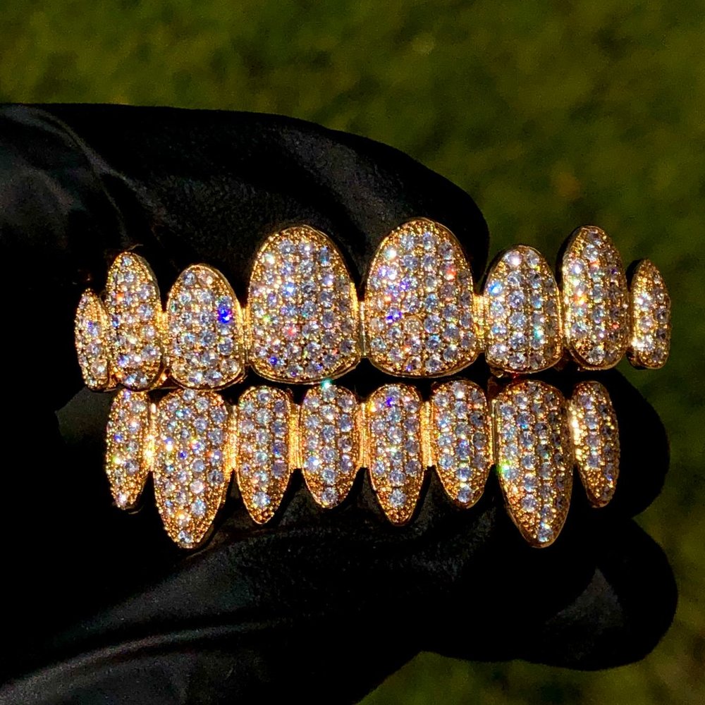 Blinged- out  gold Grillz top and bottom